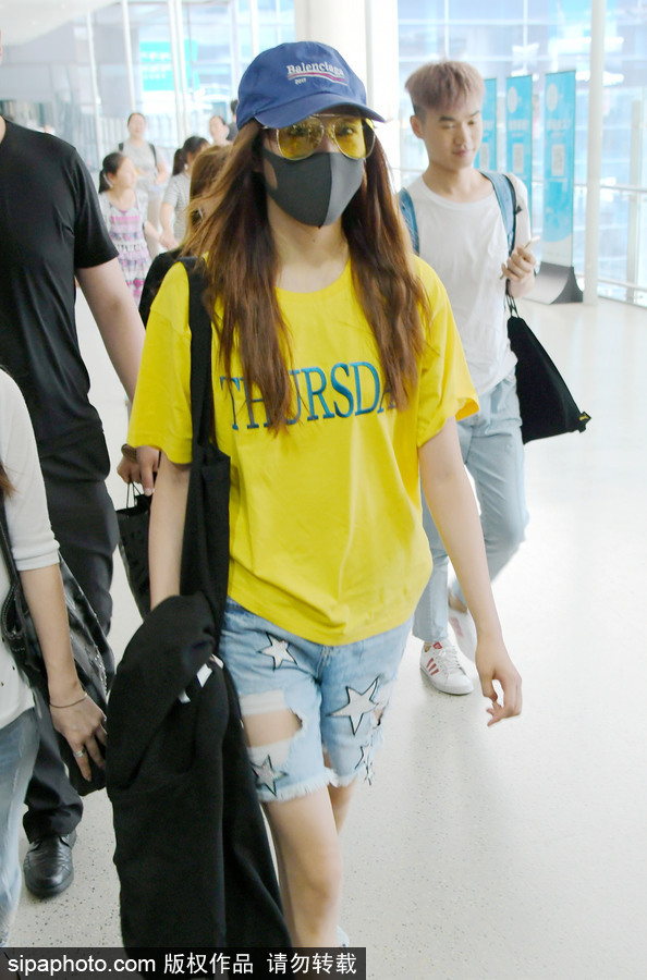 關曉彤黃T短褲踩拖鞋現身上海機場 獲眾人護駕見鏡頭比V賣萌